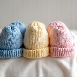 Small, colorful knitted preemie hats