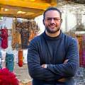 Mark L., selling his knitwear at Austin farmers markets